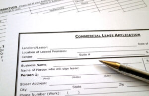 Pen resting on commercial lease documents.