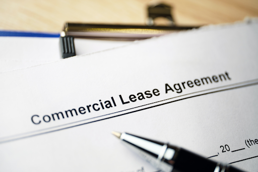 Commercial lease agreement document with a pen lying on it.
