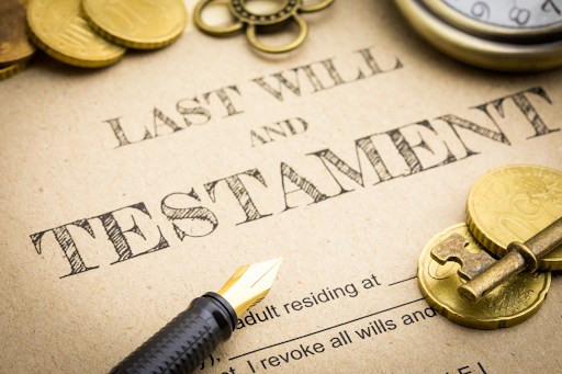 Document reading "Last Will & Testament" with a pen, key, and gold coins.